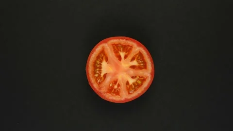 Rotating tomato on a black background. Fresh juices, vegetable, vitamin and Stock Footage 168509916