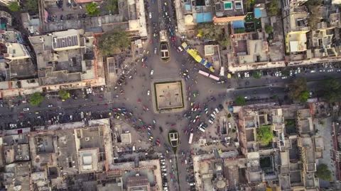 Rotating top angle aerial drone shot of busy Indian city crossroads with traffic Stock Footage 249836694