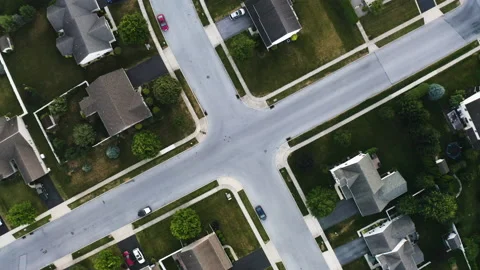 Rotating top-down drone shot of a suburban intersection 库存影片 231454921