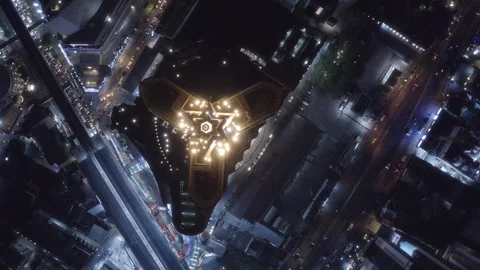 Rotating top shot of a triangular shaped roof of an illuminated building in Stock Footage 313050523