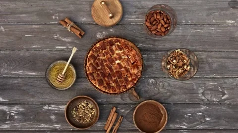 Rotating top view of delicious apple pie with cinnamon and nuts Stock Footage 334572572