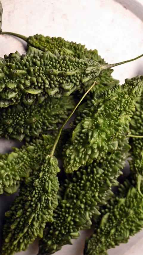 Rotating Top View of Fresh Bitter Gourd (Karela) – Green Vegetable Footage Stock Footage 329357420
