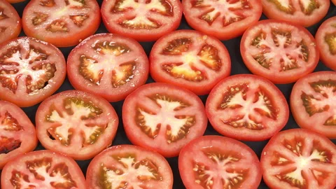 Rotating Top View of Fresh Juicy Red Tomato Slices Stock Footage 342774800