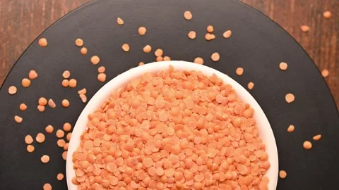 Rotating Top View of Masoor Dal (Red Lentils) in Bowl – Pulses Texture Footage Stock Footage 329355031