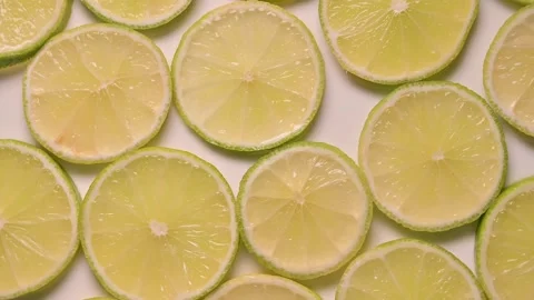 Rotating top view of slices of lime lemon Stock Footage 141539931