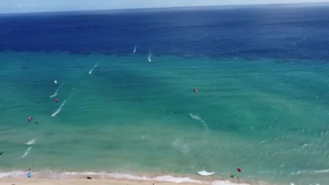 Rotating top view of surfers riding on the ocean waves in fuerteventura Stock Footage 258836868