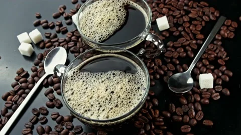 Rotating two cups with coffee on coffee beans and carica sticks Stock Footage 141895836