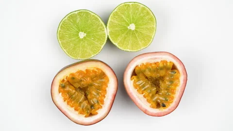 Rotating Two Green Lime And Two Passion Fruit Halves On White Background Stock Footage 323586934