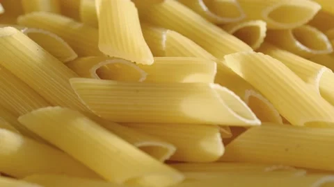 Rotating uncooked pasta . Stack of traditional dry raw macaroni. Nobody Stock Footage 169329898