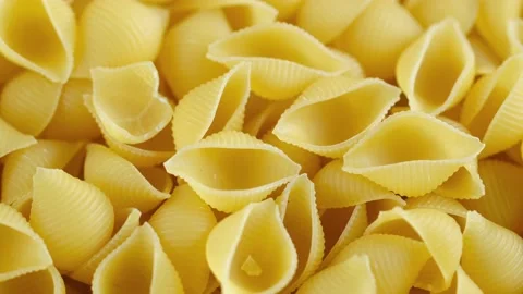 Rotating uncooked pasta . Stack of traditional dry raw macaroni. Nobody Stock Footage 169690215