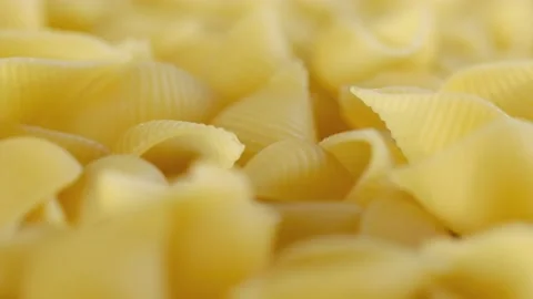Rotating uncooked pasta . Stack of traditional dry raw macaroni. Nobody Stock Footage 171754744
