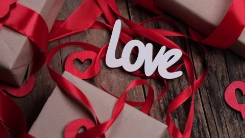 Rotating Valentine's Day background with boxes, gifts, red ribbons and hearts Stock Footage 167276371