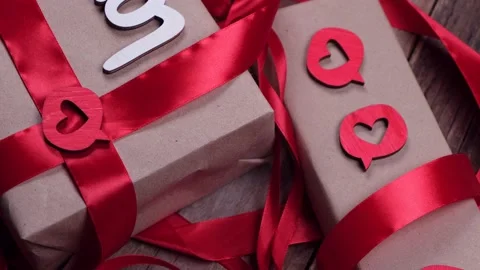 Rotating Valentine's Day background with boxes, gifts, red ribbons and hearts Stock Footage 167276388