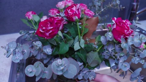 Rotating Vase to Adjust Rose Bouquet for Best Angle at Sink Stock-Footage 319920248