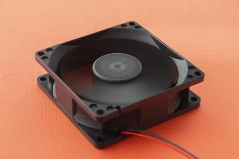 Rotating vector computer fan, 12 volt, on orange background Stock Photos