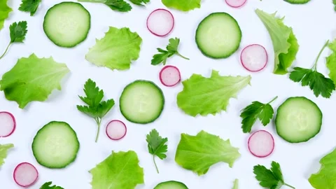 Rotating vegetable background of lettuce leaves, cucumber slices, radishes and Stock Footage 195885123