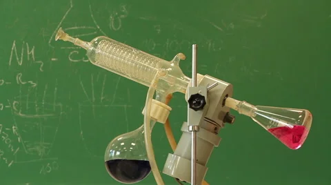 Rotating vessel with red liquid in the green chalkboard background Stock-Footage 53071557