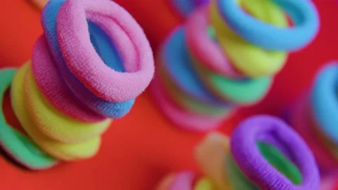 Rotating vibrant close up of a rubber bands on the red background. Stock Footage 182847385
