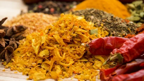 Rotating view of beautiful vibrant colourful spices on a wooden table Stock Footage 127992215