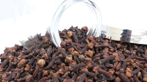 Rotating view of glass bottle placed over heap of cloves Stock-Footage 147690853