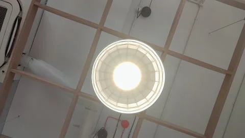Rotating View of Industrial Ceiling Light in Modern Commercial Interior Stock Footage 337795882