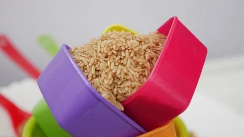 Rotating view of plastic bowls filled with sesame seeds Video stock 147694605
