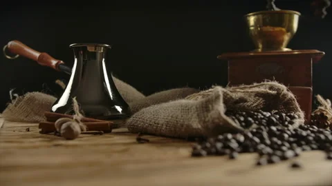 Rotating view of traditionally packed roasted coffee beans dispersed on wooddesk Stock Footage 136814600