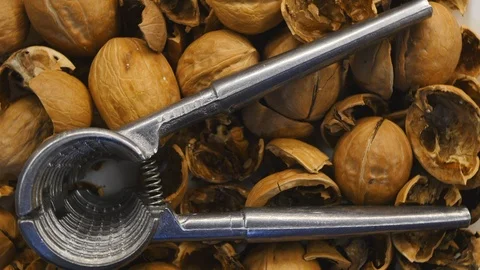 Rotating Walnut And Shell With Nutcracker On The White Plate On Turntable Top Vi Stock Footage 122998833