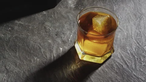 Rotating whiskey on black background Video stock 243596852