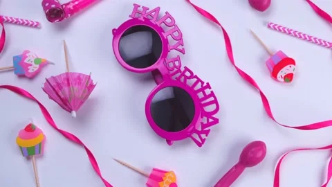 Rotating white background with glasses, balloons and tubes for birthday or party Stock Footage 211132428