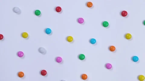 Rotating white background with multi-colored candies. Concept for celebrating a Stock Footage 197332820