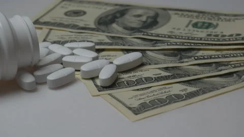 Rotating white pills with dollar bills. Expensive drugs, pharmaceutical busines Stock Footage 119795278