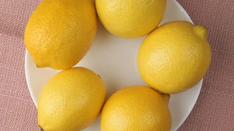 Rotating white plate full of lemons Stock Footage 346177998