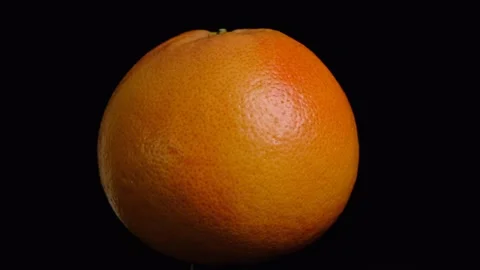 Rotating whole grapefruit on black background Stock Footage 155783976