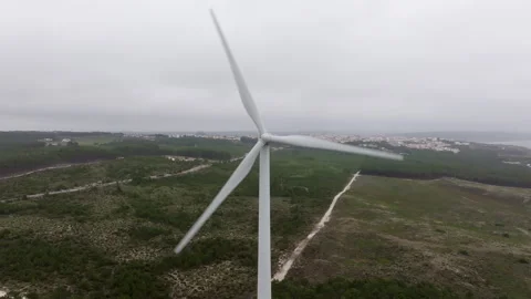 Rotating wind turbine against a backdrop of a cloudy sky Stock Footage 300623588