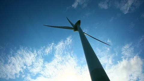 Rotating wind turbine and moving clouds in the background, lower angle. Stock Footage 247641869