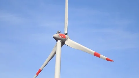Rotating wind turbine propeller blades in the blue sky Stock Footage 75538423