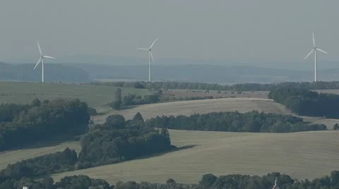 Rotating wind turbines on a field in Germany Stock Footage 12479243