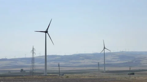 Rotating wind turbines on wind farm hill,green renewable energy production Stock Footage 209374297