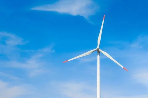 Rotating windmill generating renewable energy with wind power. Sustainability Stock Photos