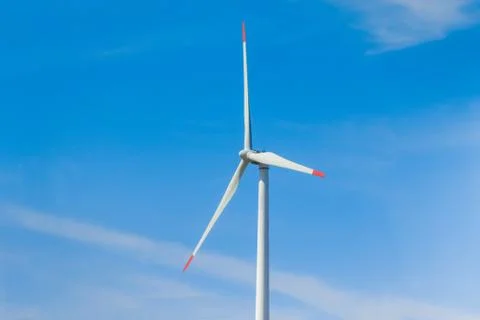 Rotating windmill generating renewable energy with wind power. Sustainability Stock Photos