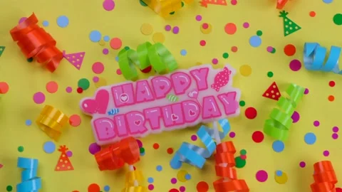 Rotating yellow background with confetti, serpentine for birthday Stock Footage 215610492