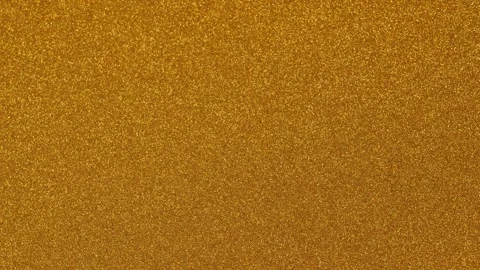 Rotating Yellow Gold Background with a Glitter Pattern Texture of a 4K Stock Footage 323859721