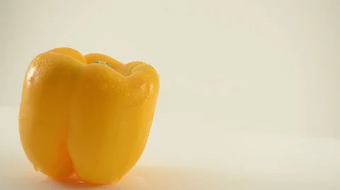 Rotating Yellow Pepper Against White - Crane Down Stock Footage 22648583