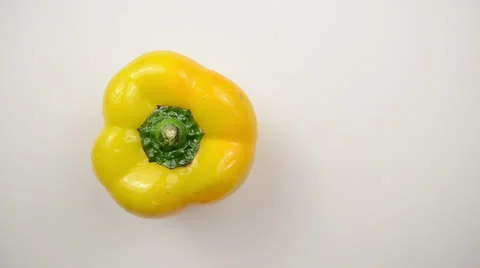 Rotating Yellow Pepper Against White - Overhead Dolly Right Stock Footage 22803534