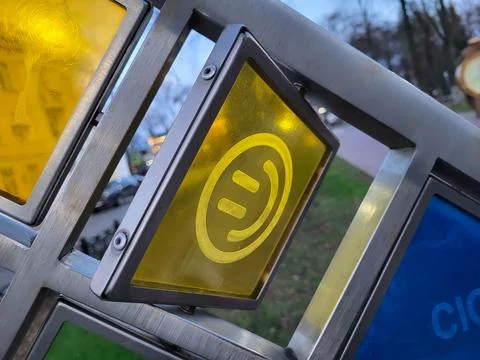A rotating yellow square with a funny face on a stained-glass window in the s Stock Photos