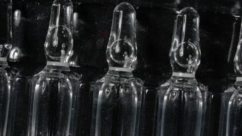 Rotation of ampoules close-up. Black background. A drug for the treatment of Stock Footage 143571028
