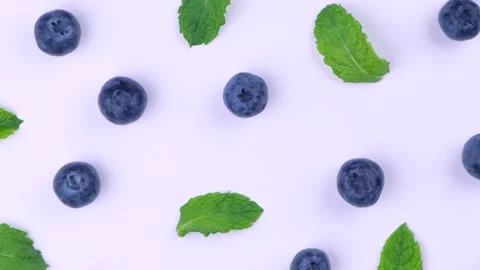 Rotation background of berries , blueberries with mint leaves on a white Stock Footage 195035498