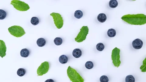 Rotation background of berries , blueberries with mint leaves on a white Stock Footage 197164151