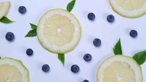 Rotation background of blueberries and lemon slices on a white background Stock Footage 201938586